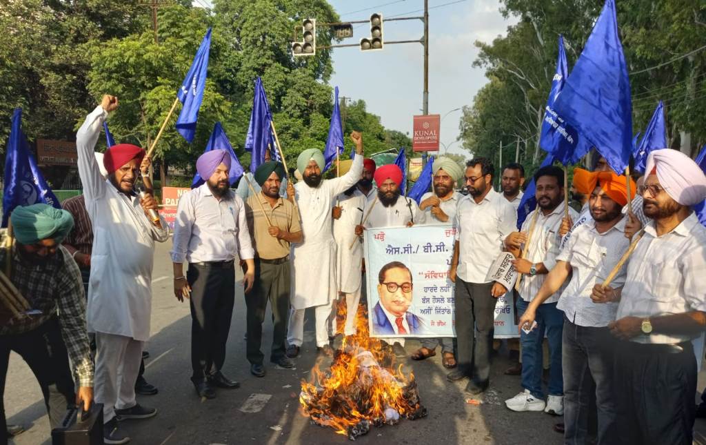 In protest against not giving due reservation quota to SC and BC categories in direct recruitment of 1013 lecturers effigies of WM EM WS and ES were burnt